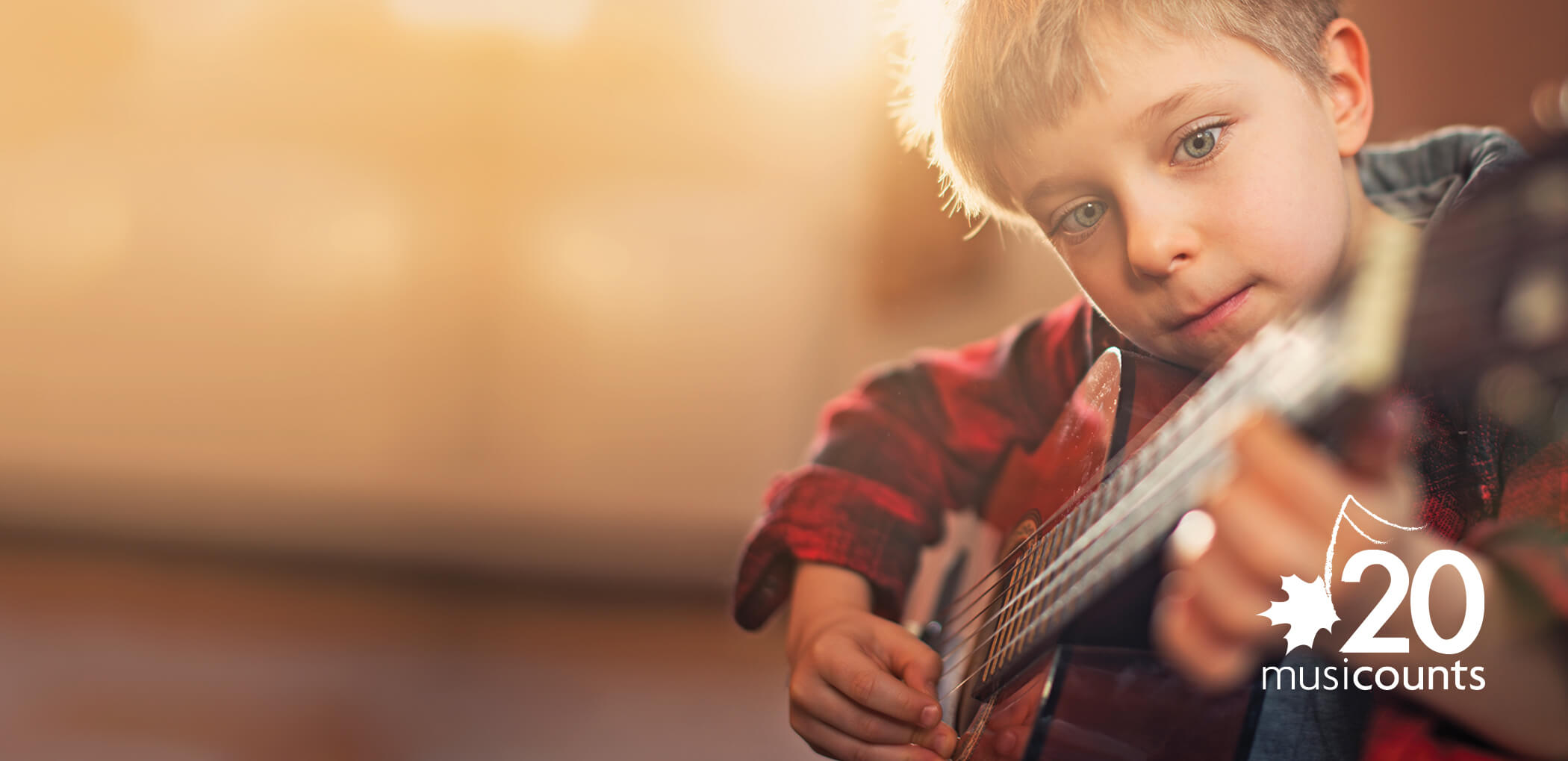 Young boy playing the guitar